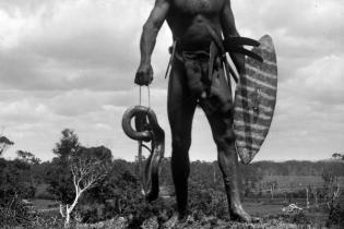 Charlie Murray with killed snake near Port Macquarie (note house and Lake Road in background).